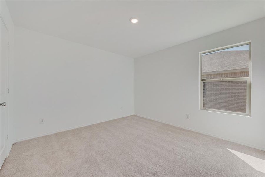 Empty room featuring light carpet