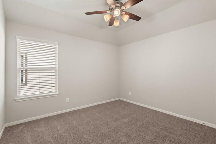 Your secondary bedroom features plush carpet, fresh paint, closet, and a large window that lets in plenty of natural lighting.