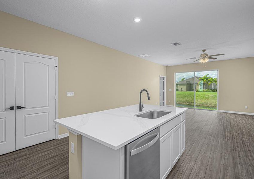 The kitchen island overlooks the dining and family rooms