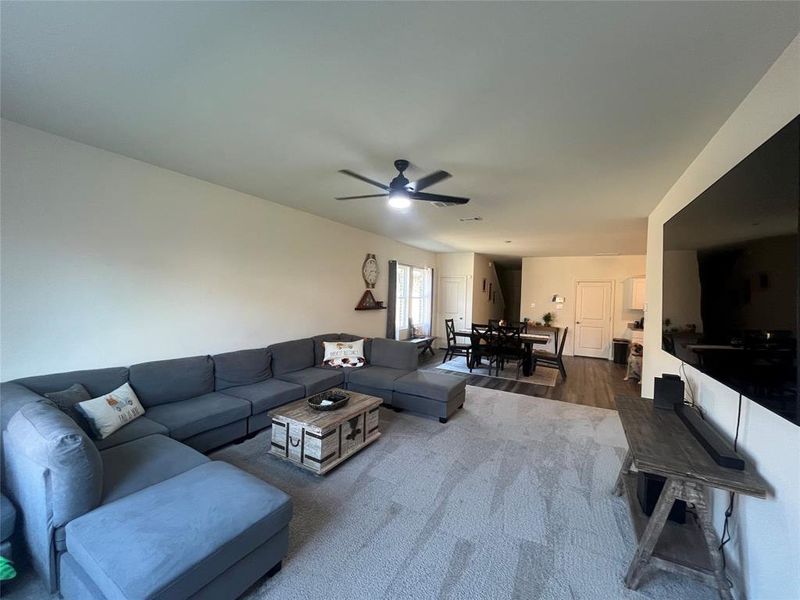 Living room featuring dark hardwood / wood-style floors and ceiling fan