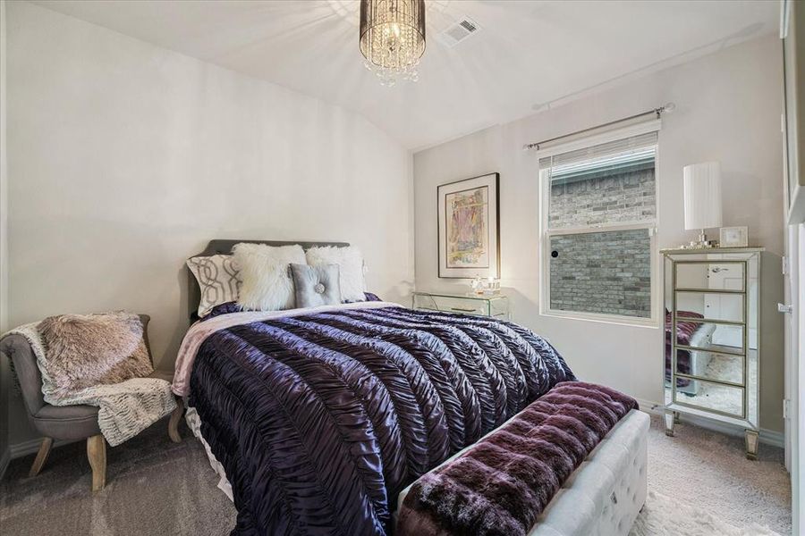 Carpeted bedroom with lofted ceiling. Chandelier as photo'd is now removed from home and replaced with builders fixture.