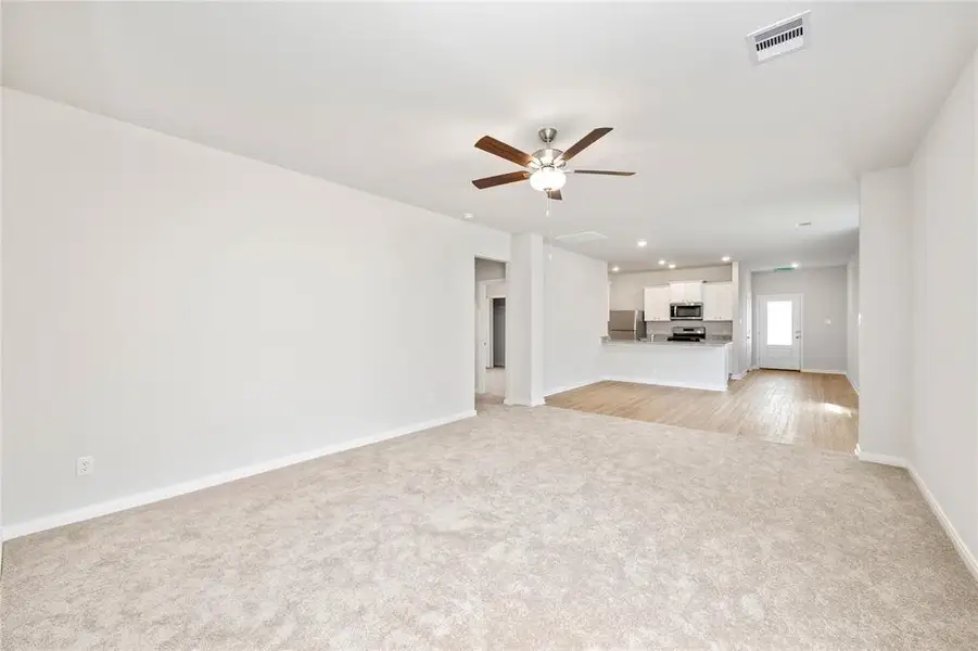 Spacious living room, open to the kitchen and dining area.