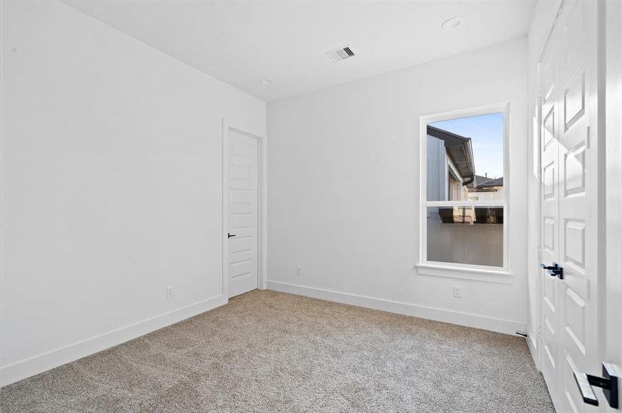 Secondary bedroom on third floor.