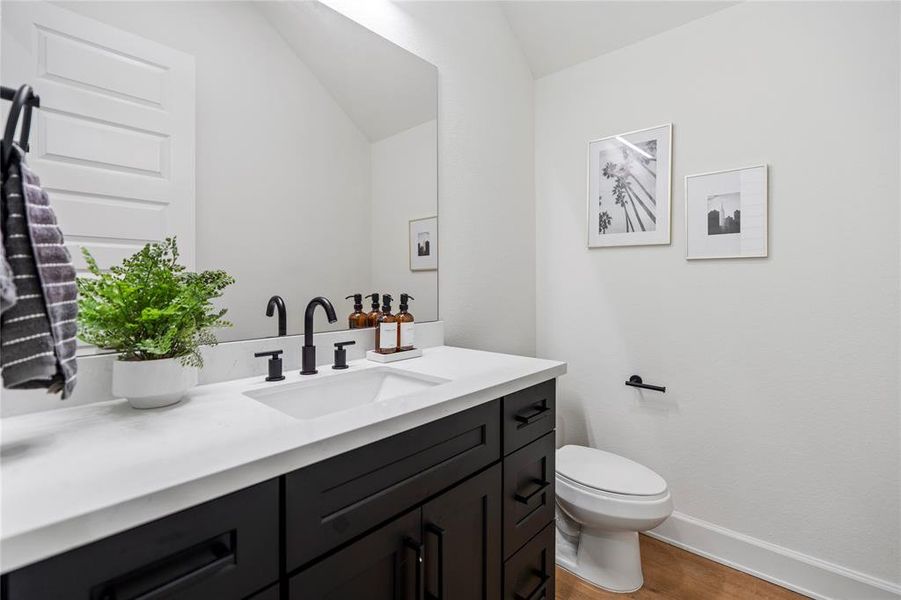 A generously sized powder room retreat, boasting a clean and contemporary aesthetic. With sleek design and thoughtful details, this space ensures a luxurious experience for guests, combining style with comfort.