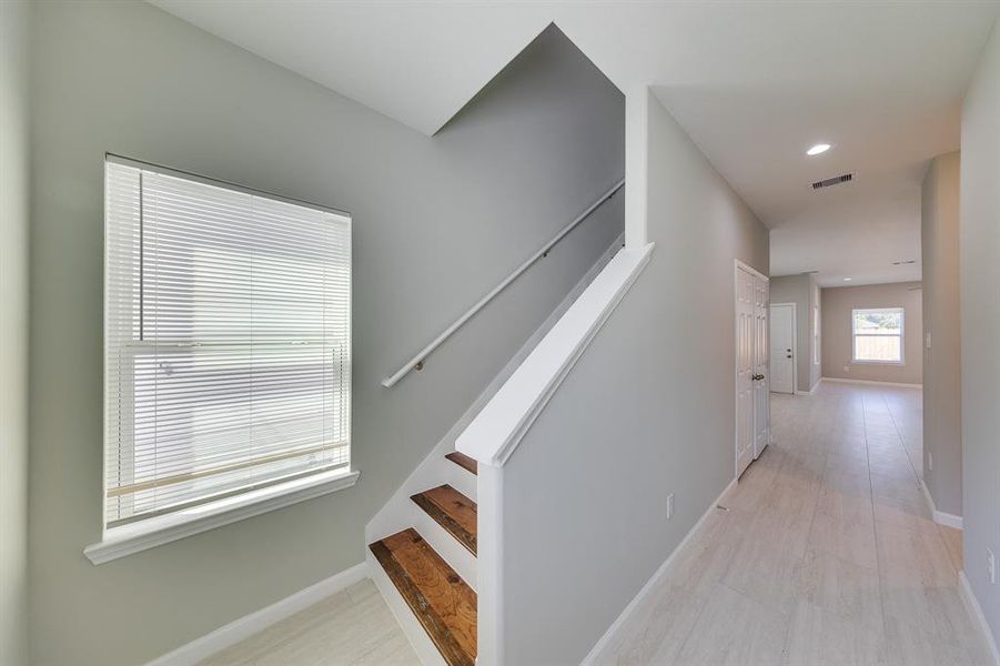 Right as you enter the home, you’re greeted by a welcoming foyer that leads directly to the stairs to the second floor. The staircase is thoughtfully positioned, offering a seamless flow into the upper level while adding a touch of elegance to the home’s entryway.