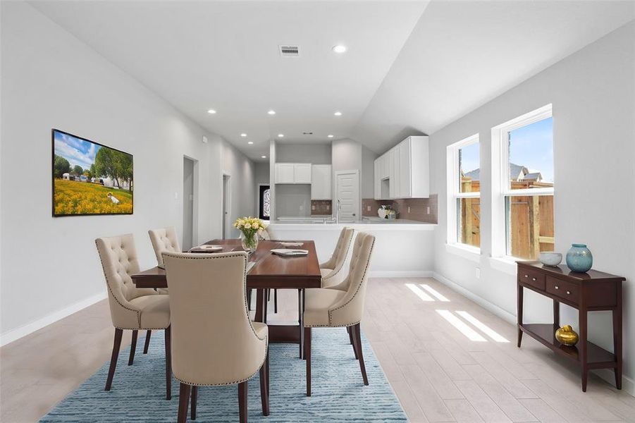 This lovely dining room is perfect for starting the day out on the right foot! This space showcases custom paint, high ceilings, recessed lighting, large windows adding to the ample natural light, and tile flooring!