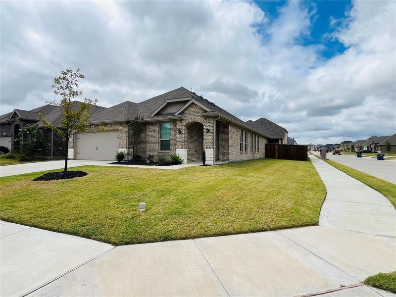 View of front of home with a garage and a front yard