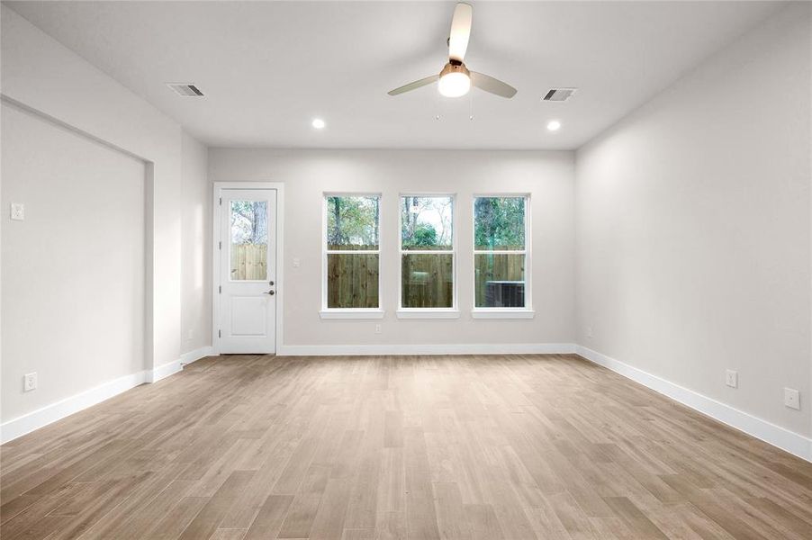 Spacious living room space with natural lighting and high ceilings