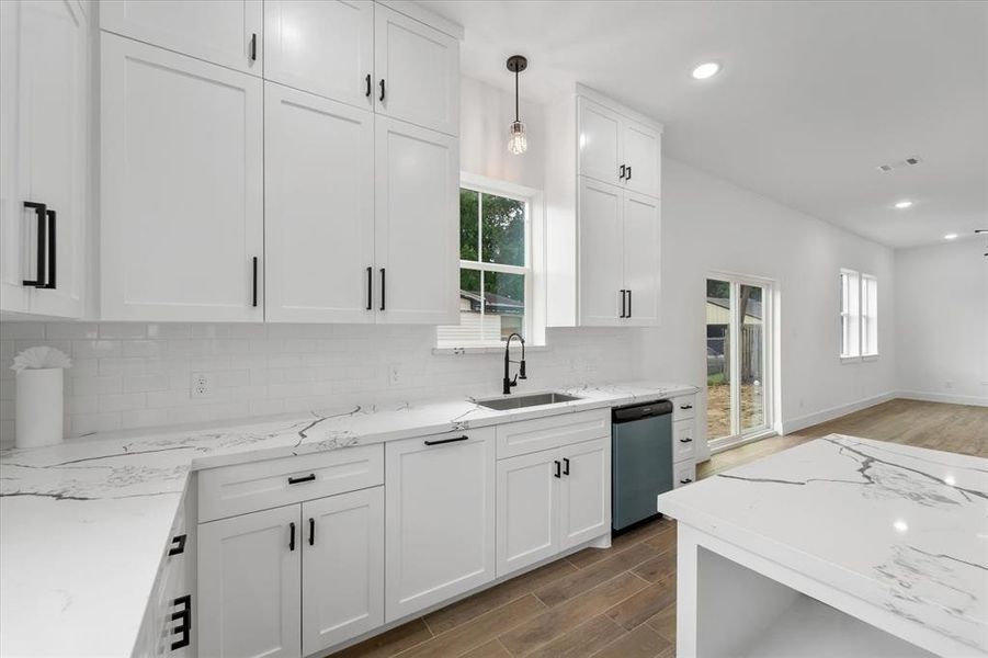 Additional features in the kitchen include two-tiered solid wood cabinetry and a large island with a dedicated area for your microwave to reduce counter clutter.