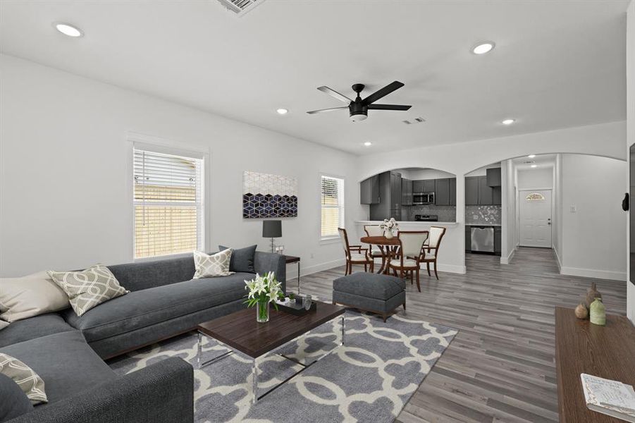 Virtually Staged: This area is complete with large windows with privacy blinds, recessed lighting, and a ceiling fan.