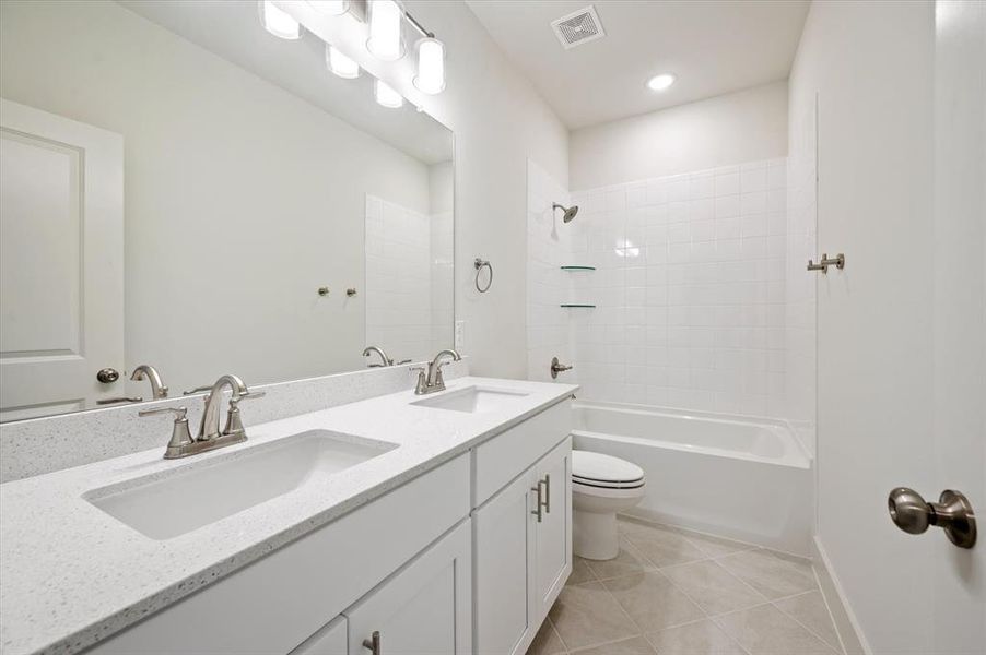 Everyone has their own space in this stylish guest bath.