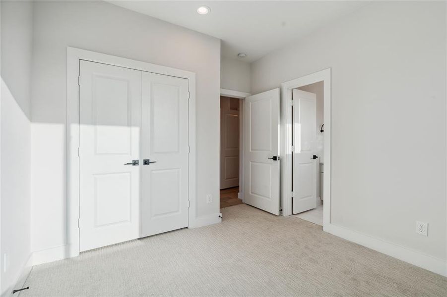 This secondary bedroom on the third floor features an oversized closet as well as a full bath.