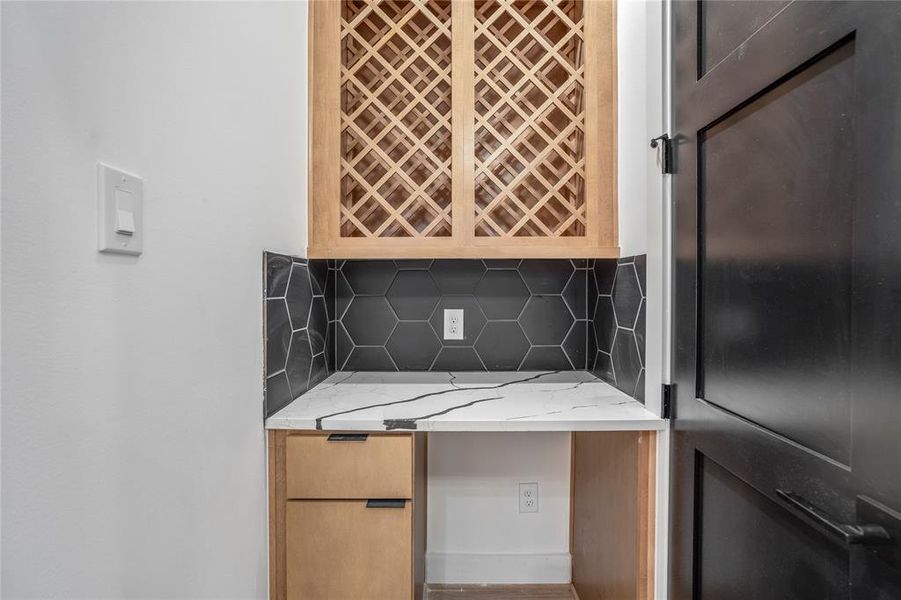 Custom-designed wine bar with ample storage above and below. Door to the right is your coat closet.