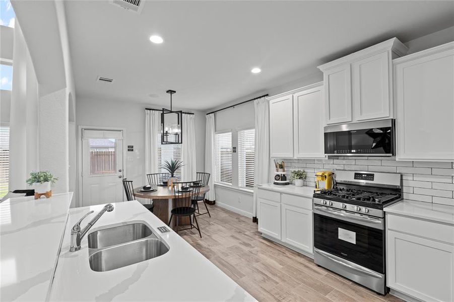 Enjoy the functionality of a large panty, countertops and cabinets.  **This image is from another Saratoga Home with similar floor plan.