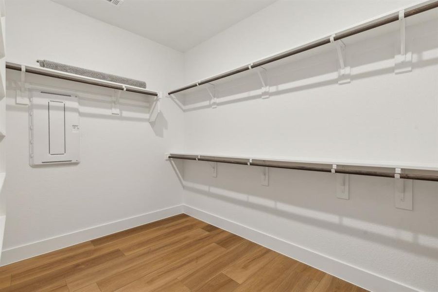 Walk in closet featuring hardwood / wood-style flooring and electric panel