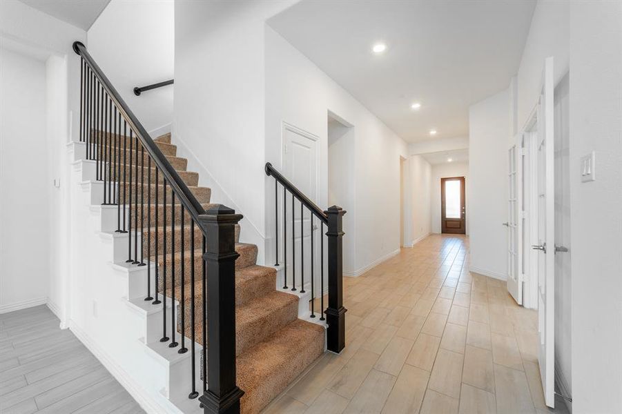 Staircase with hardwood / wood-style flooring