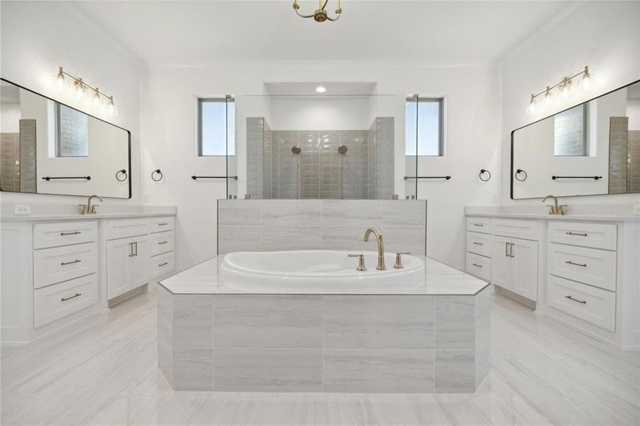 Bathroom featuring vanity, shower with separate bathtub, and a healthy amount of sunlight