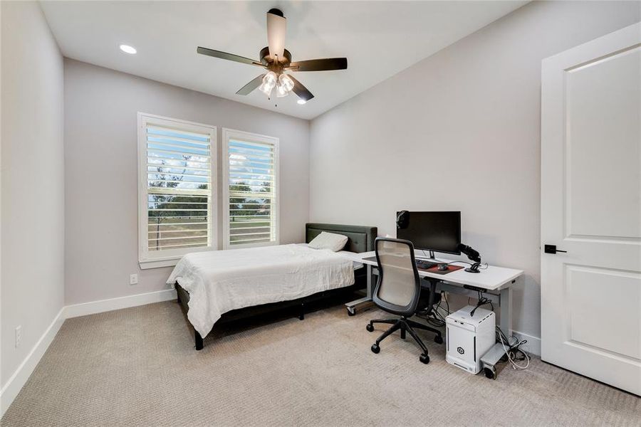 Bedroom featuring ceiling fan and light carpet