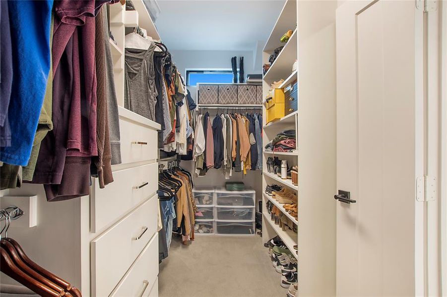 Walk in closet with light colored carpet