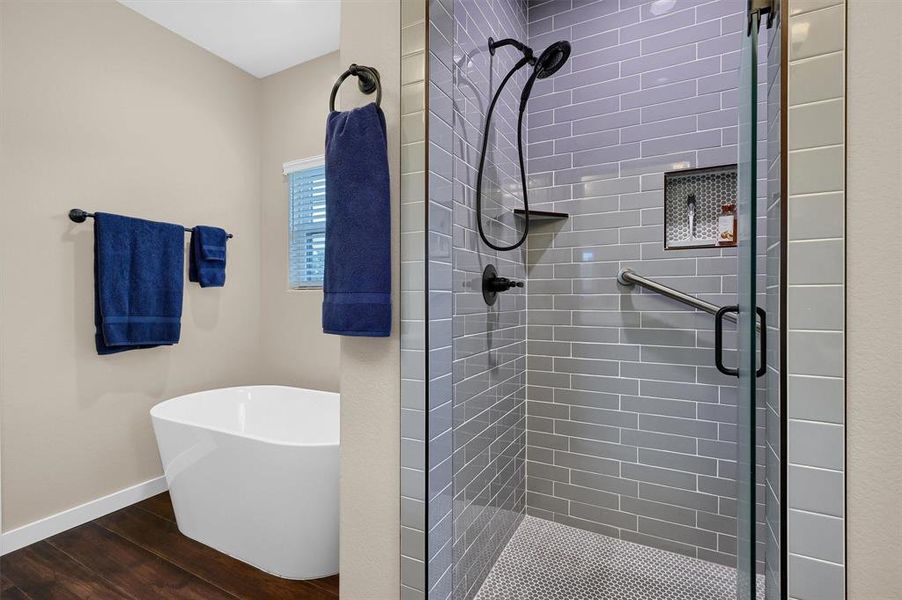 Bathroom with plus walk in shower and wood-type flooring