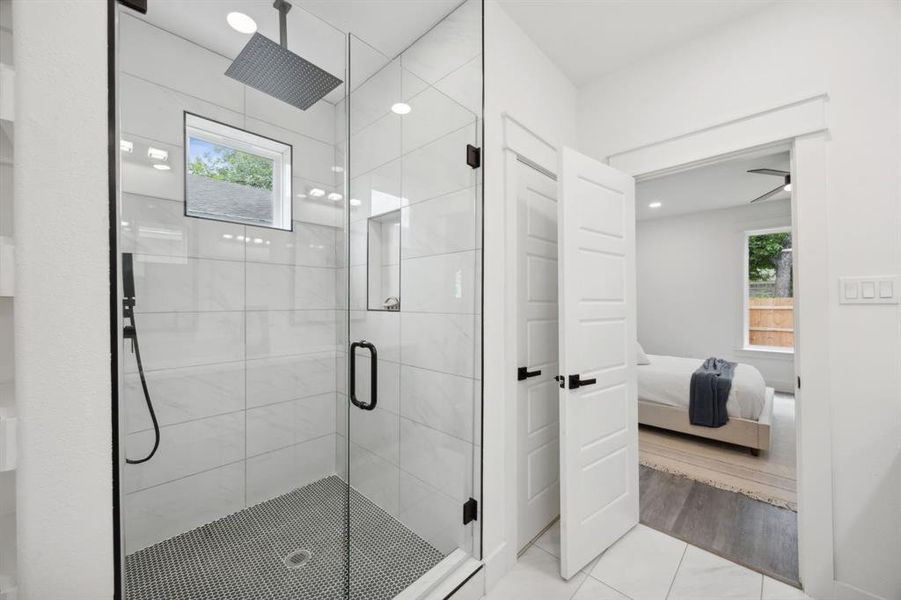 Primary bathroom featuring an enclosed shower and private toilet closet