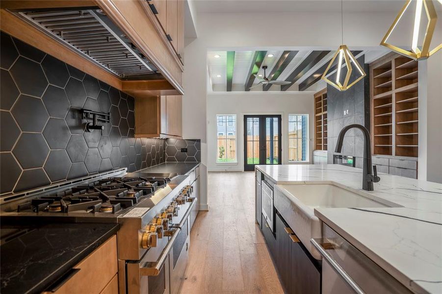 Commercial-grade appliances with pot filler over your gas stove. No details left behind in this incredible designer kitchen.