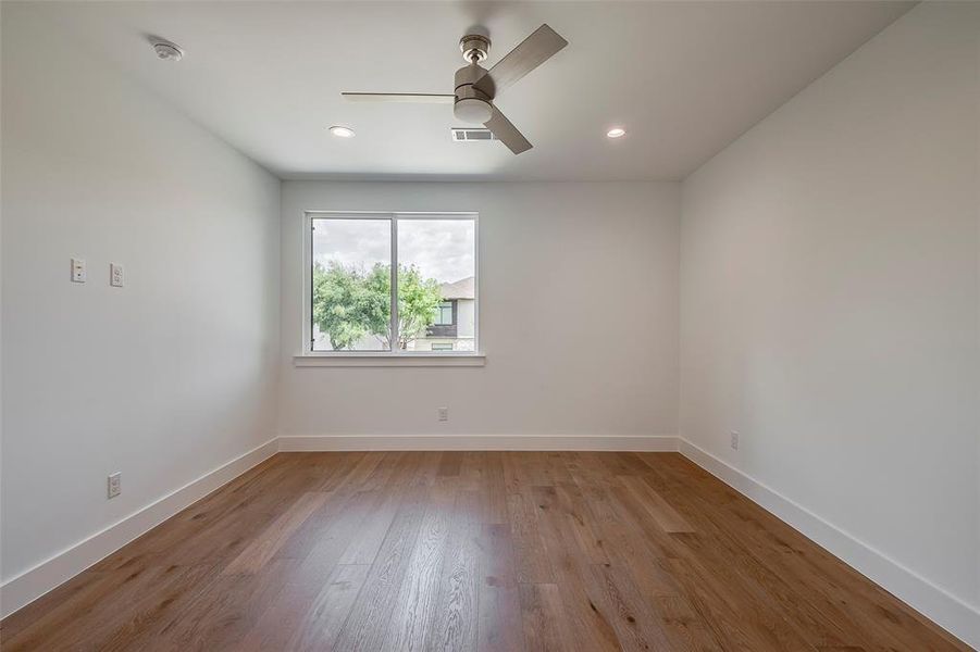 Bedroom with wood-type flooring and ceiling fan