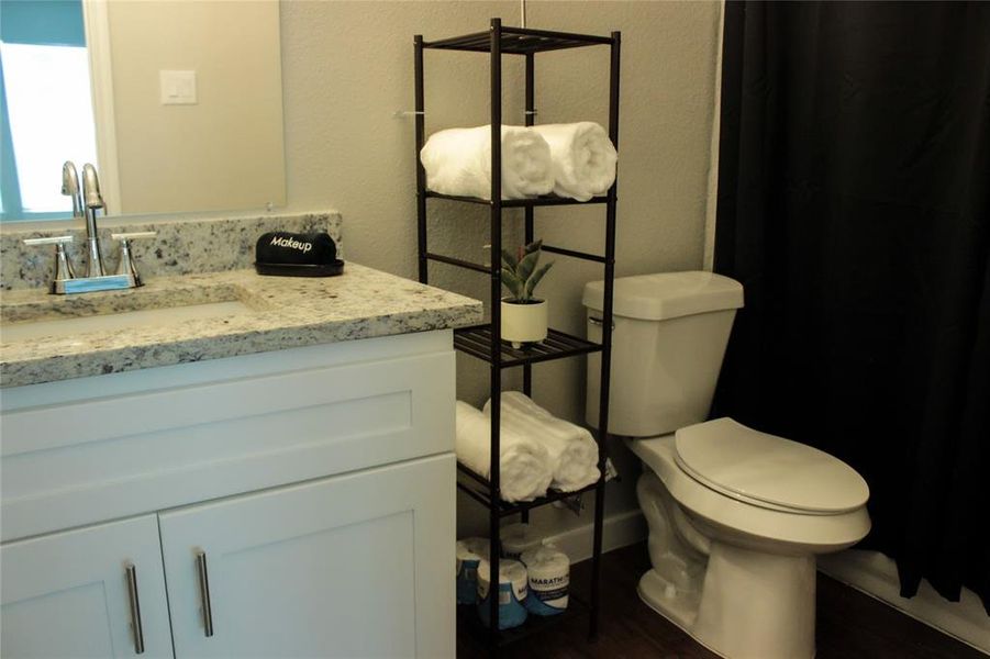 Bathroom featuring vanity and toilet