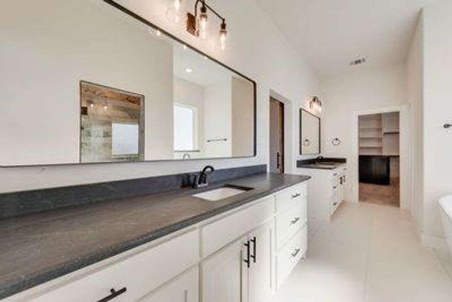 Bathroom featuring vanity and tile patterned floors