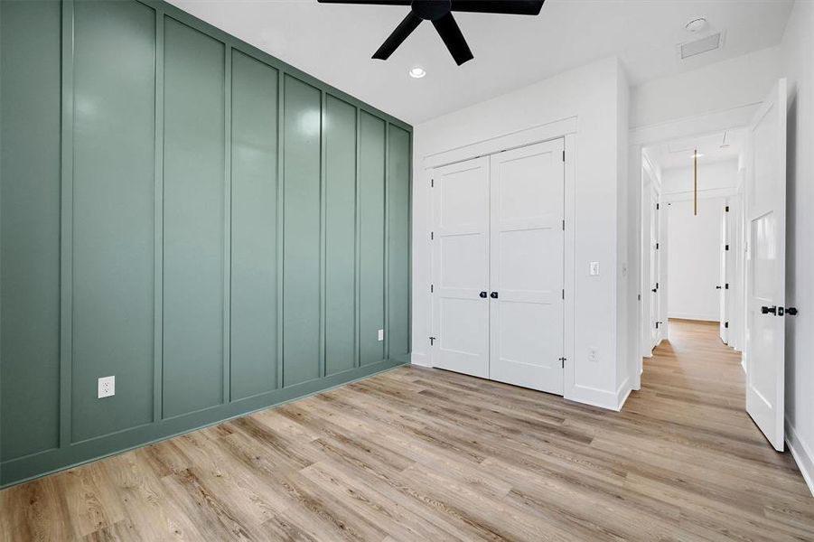 Unfurnished bedroom featuring light wood-type flooring and ceiling fan