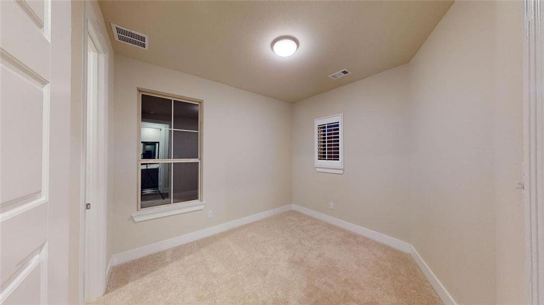 Unfurnished room with light carpet