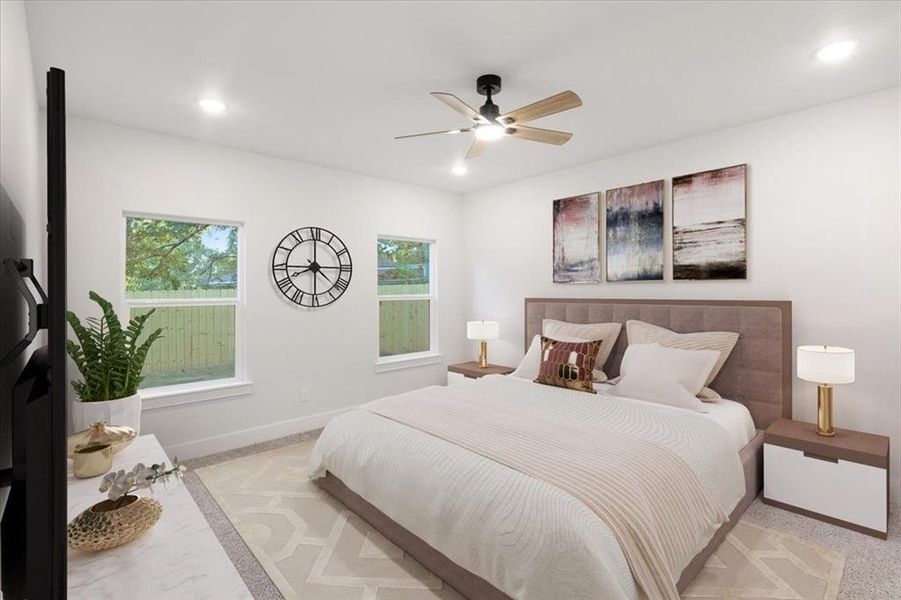 Carpeted bedroom featuring ceiling fan