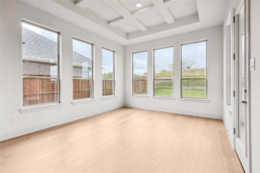 Unfurnished sunroom with beam ceiling and coffered ceiling