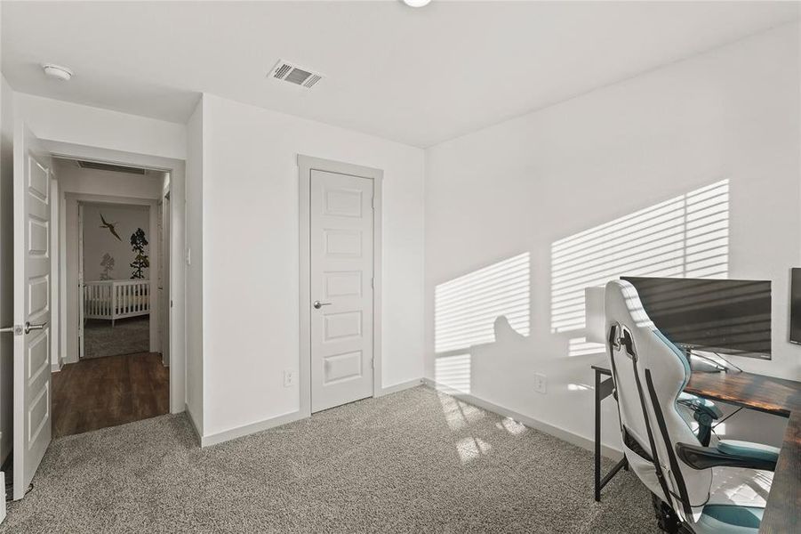 Another view of the first guest bedroom with ample closet space