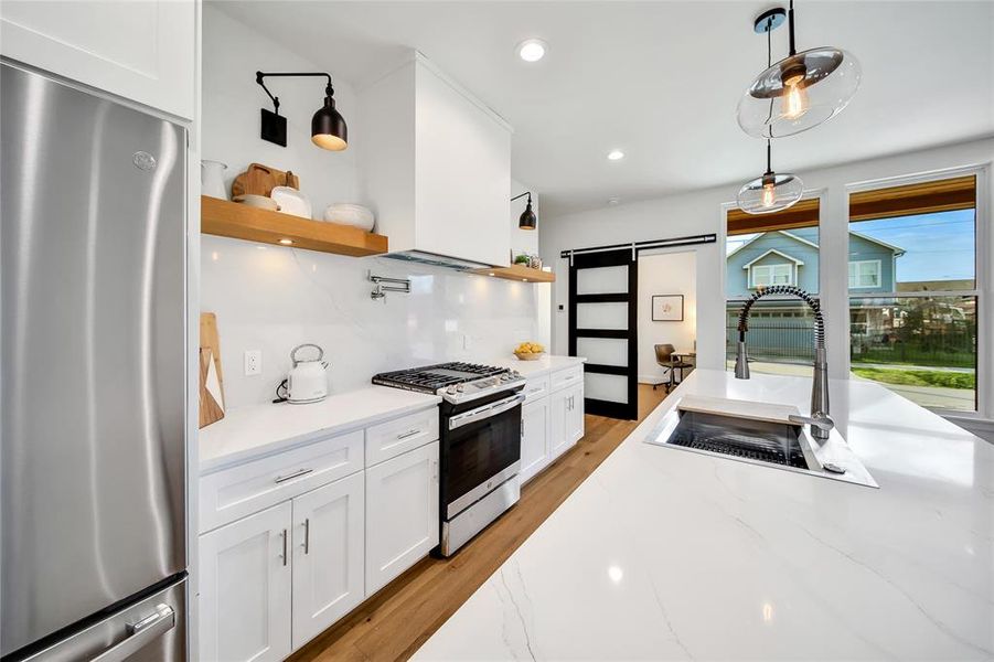 This photo was taken in another staged property with the same finishes and layout. Kitchen looking toward a space that could be used for a small home office.