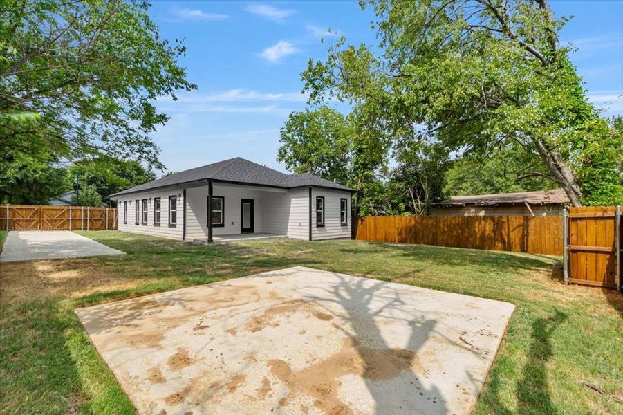 Back of house featuring a patio area and a lawn