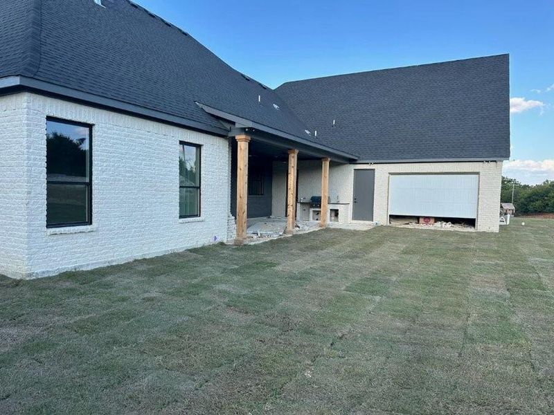 Back of house featuring a lawn