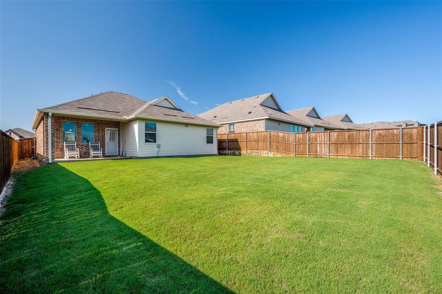 Large backyard that is perfect for pets or play with a covered patio for morning coffee.