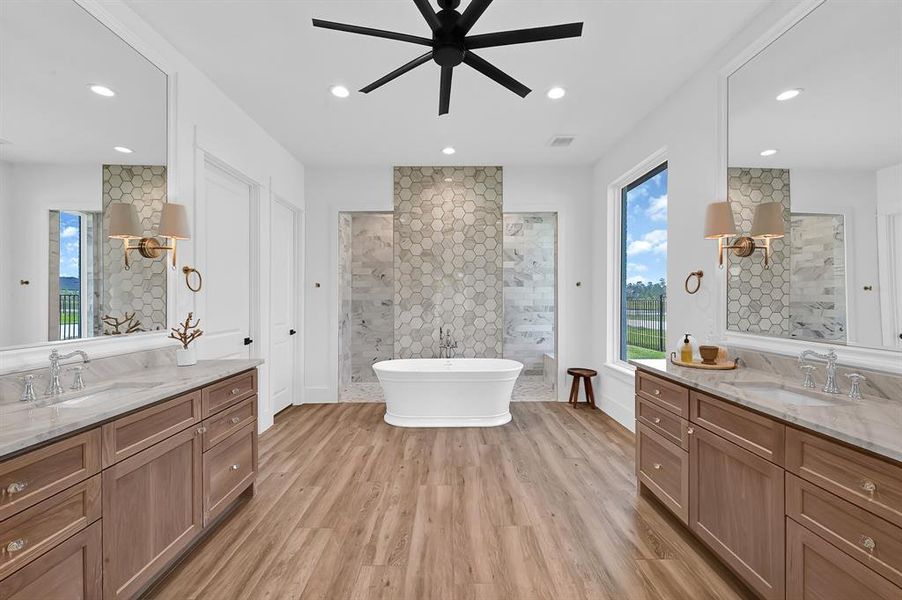 His/her vanities, soaking bathtub, and walk in shower.