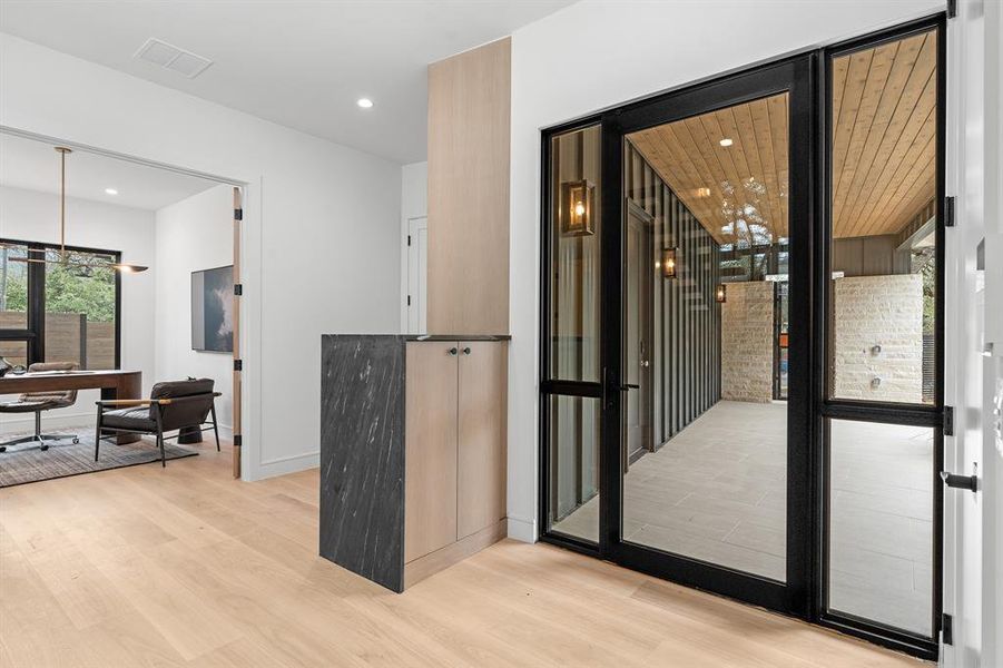 The foyer features a custom Western front door package and a bench with plenty of storage just inside both the door from the garage and the formal front door - the perfect place to unload bags, keys and mail when you get home.