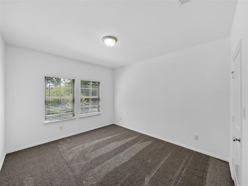 Empty room with dark colored carpet