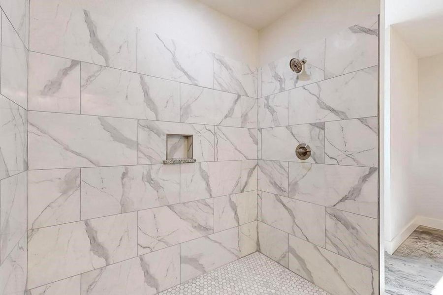 Bathroom featuring tiled shower