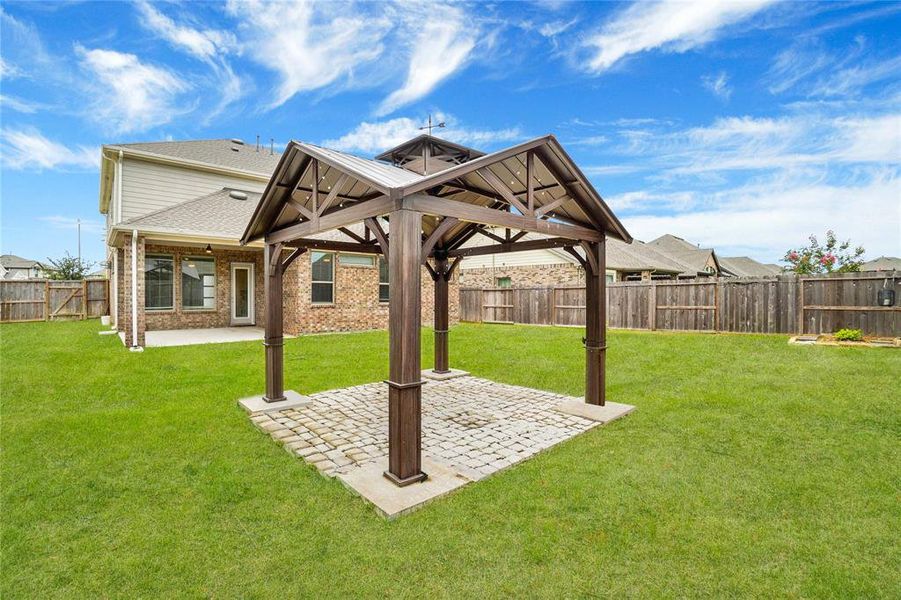 Spacious lawn for your creative ideas and a charming pergola over a stone patio, perfect for outdoor relaxation and entertainment.