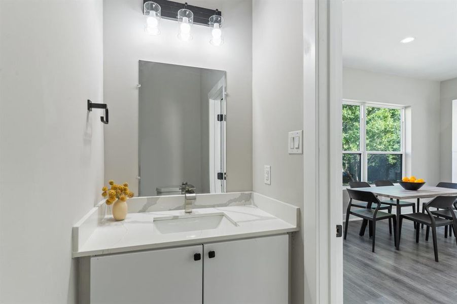 Bathroom featuring vanity and wood-type flooring