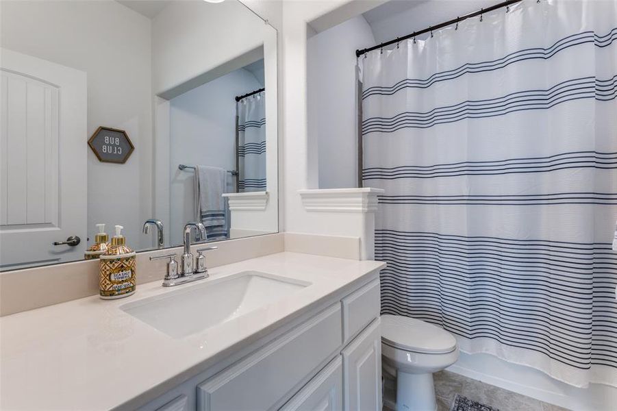 Full bathroom with shower / bath combination with vanity and toilet