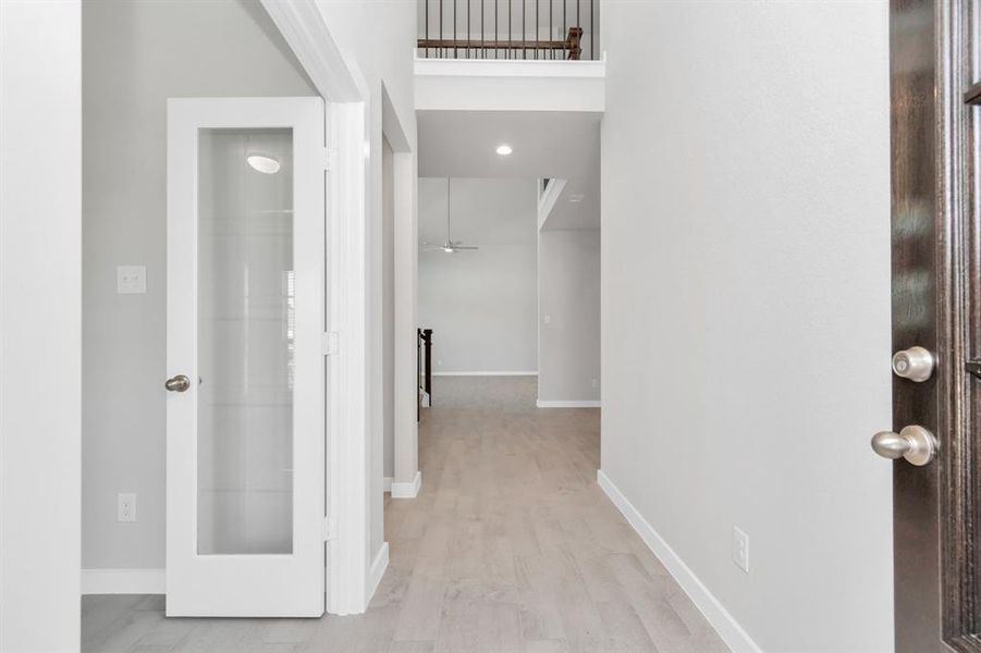 Elegant entrance with high ceilings, premium floors, and large baseboards. Sample photo of completed home with similar floor plan. As-built interior colors and selections may vary