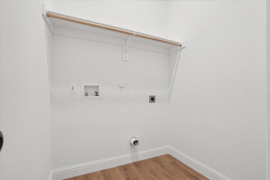 Laundry room featuring washer hookup, hardwood / wood-style flooring, gas dryer hookup, and electric dryer hookup