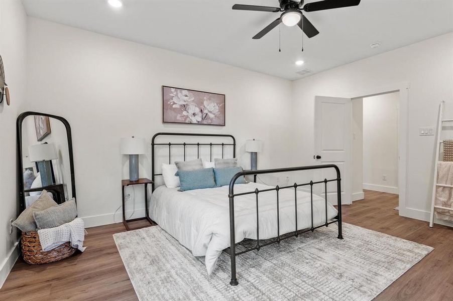 Bedroom featuring hardwood / wood-style flooring and ceiling fan