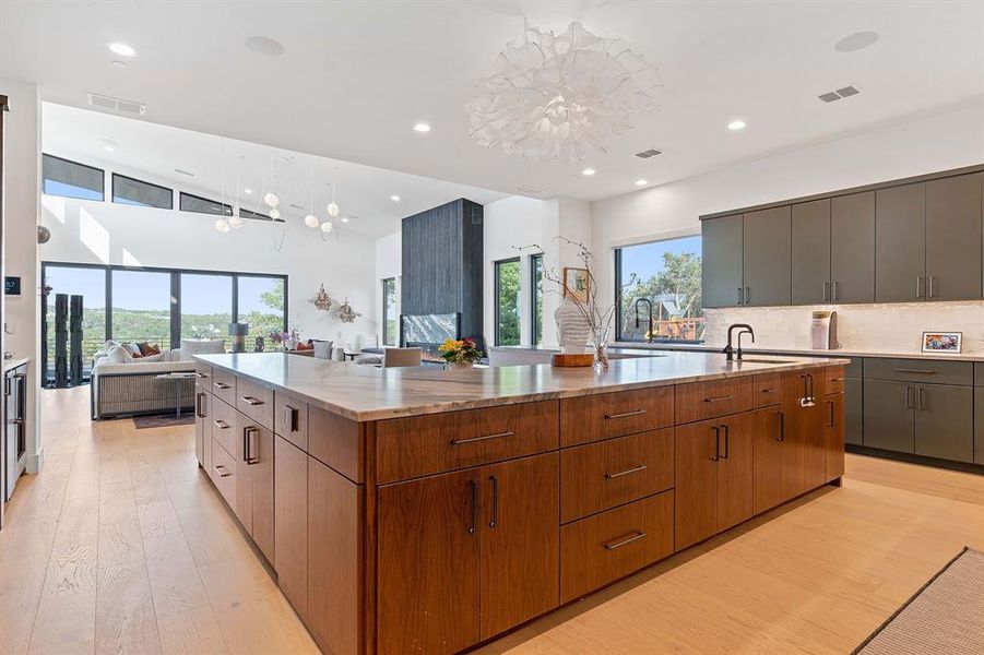 The chef's quantity of counter space and massive U shaped island allow multiple chefs to work in harmony in this generously sized gourmet kitchen.