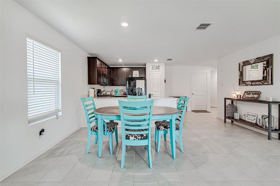 Dining space featuring light tile patterned floors